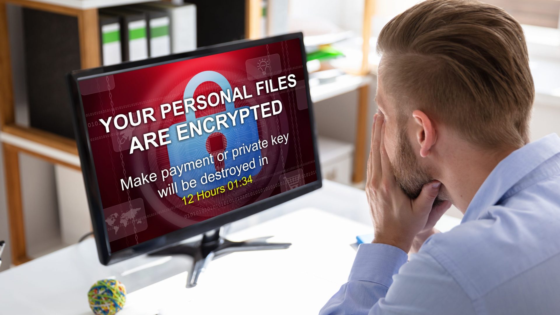 Worried,Businessman,Looking,At,Computer,With,Ransomware,Word,On,The